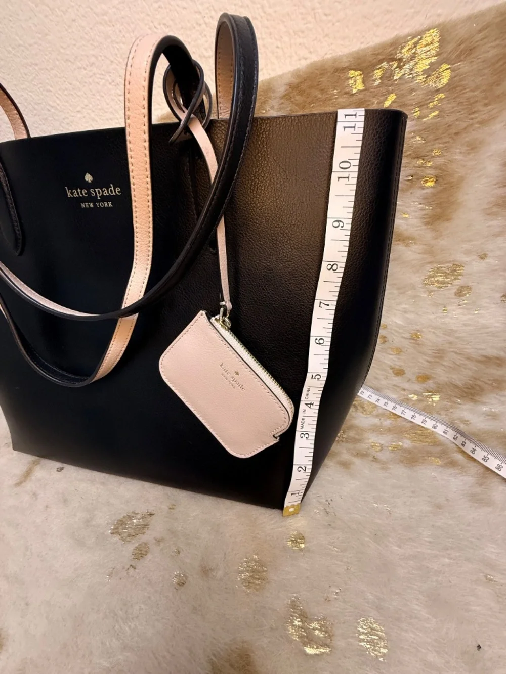 Stylish Kate Spade reversible tote in classic black with blush pink interior